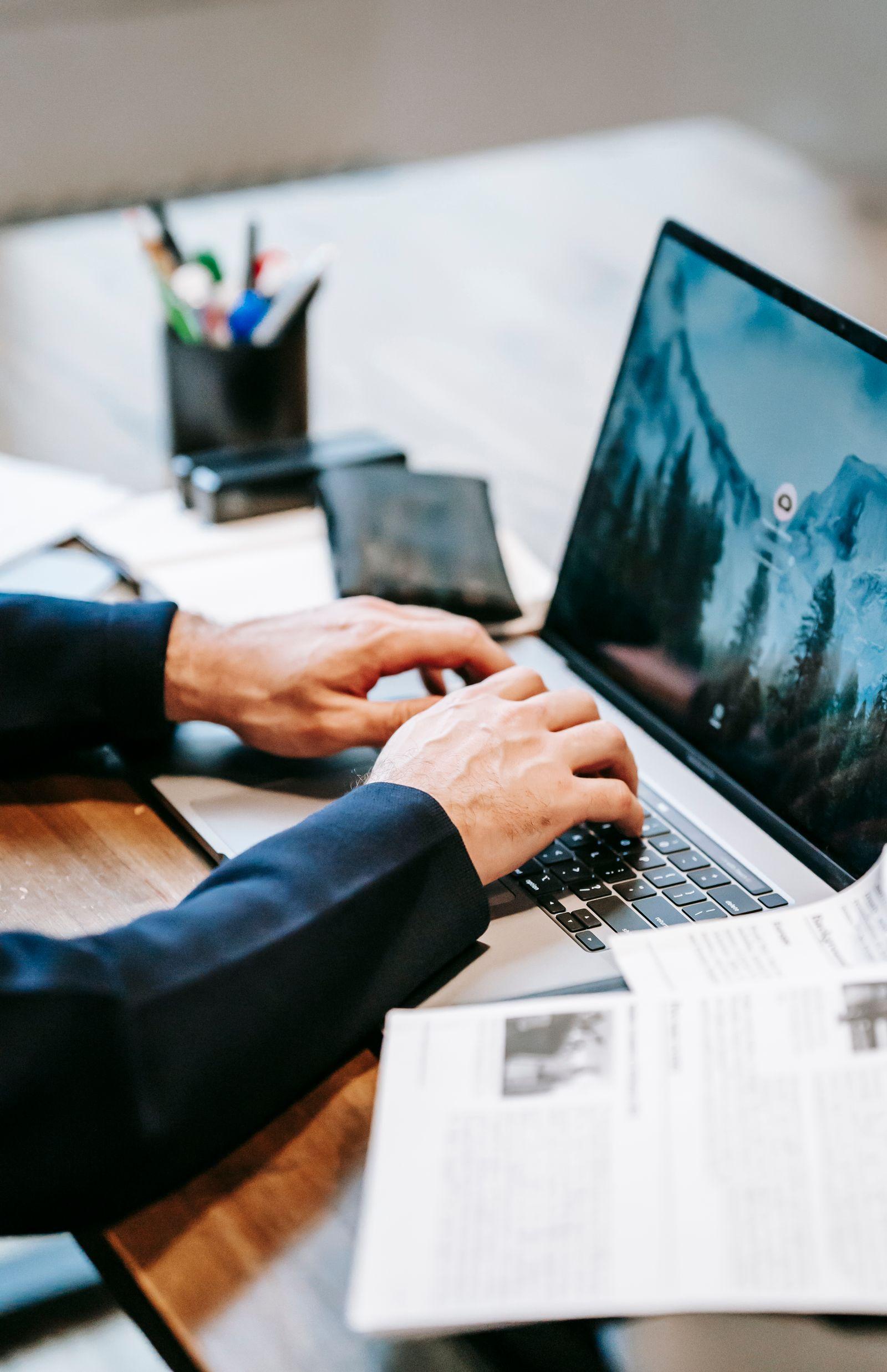 Business owner working on documents at a laptop